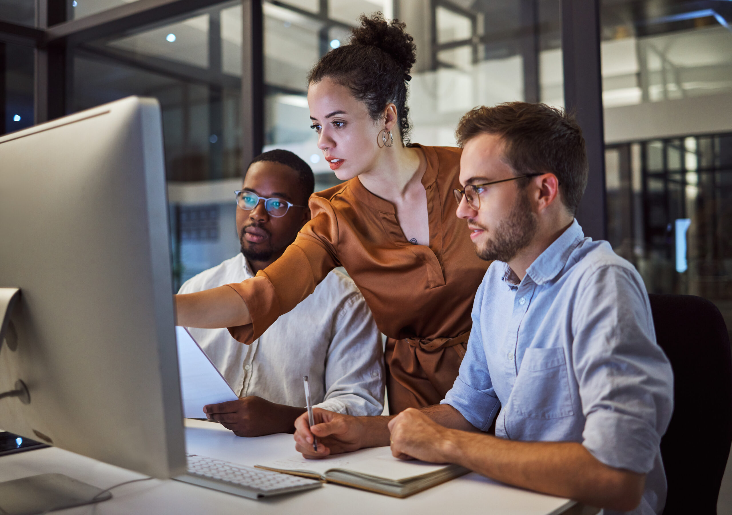 Team of diverse professionals working on computer