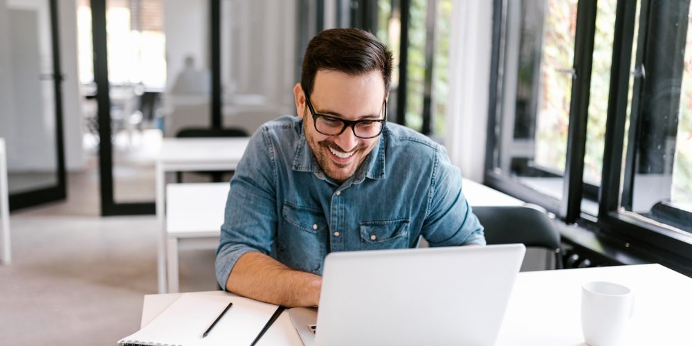 Very happy client looking at their website on laptop