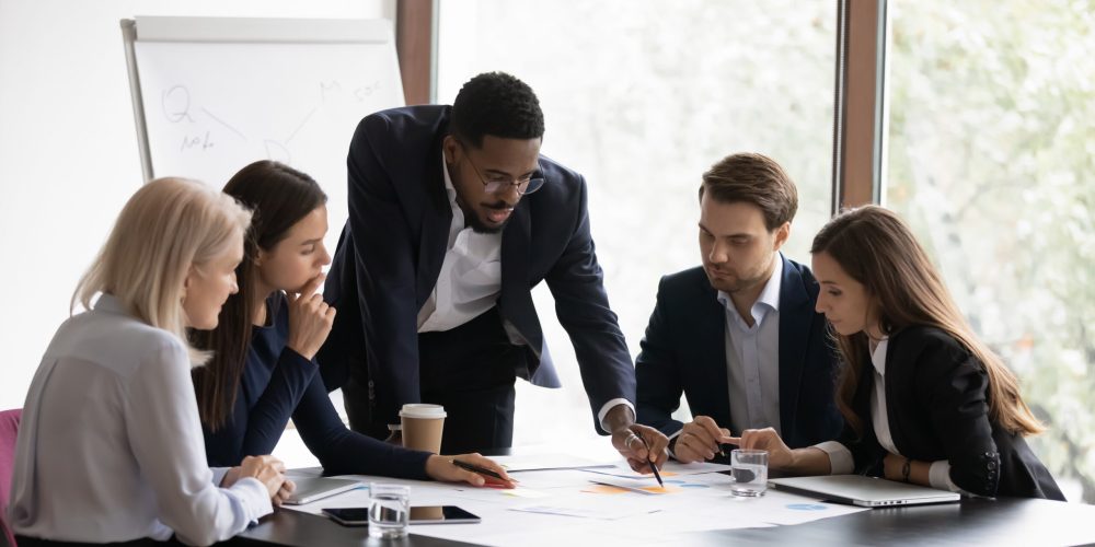 Confident biracial businessman head meeting with diverse colleagues